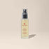 Refreshing facial Glow Protection & Shielding Mist spray in elegant bottle against a serene background